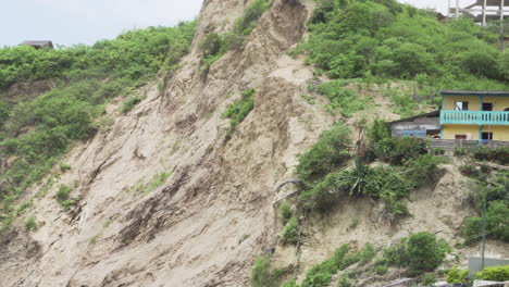 Structure-On-Coastal-Cliff-With-Birds-Flying-During-Daytime-In-Puerto-Lopez,-Ecuador