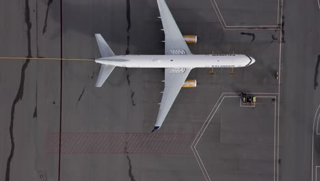 Aerial-of-two-Icelandair-Boeing-757-out-of-work-on-airport-tarmac,-travel-ban