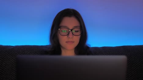 Slow-Motion-of-College-Female-Student-Doing-Homework-on-Laptop-Computer-at-Night-Close-Up