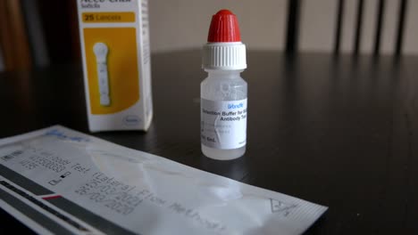Unopened-Wondfo-Rapid-Antigen-Covid-test-kit,-packet-of-lancets-and-buffering-solution