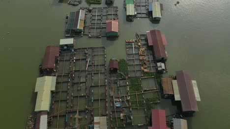 Floating-fish-farming-community-in-Bien-Hoa-on-the-Dong-Nai-river,-Vietnam-on-a-sunny-day