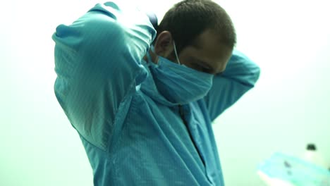Male-Staff-Putting-On-Face-Mask-In-Karachi-Hospital-Ward