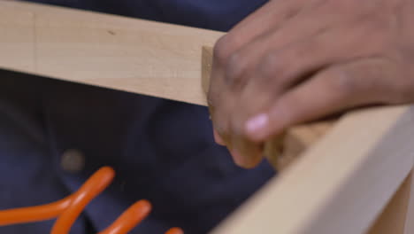 Closeup-Of-A-Furniture-Maker-Making-A-Wooden-Chair,-Nails-And-Glue-Holding-Wood-Together