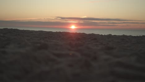 Sunset-of-the-island-Sylt-with-the-sandy-beach-in-the-foreground