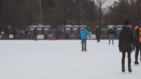 Slomo-pan-left-shot-of-people-ice-skating-during-the-day