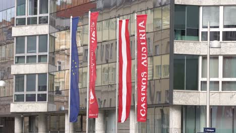 Casinos-Austria-headquater-flags-with-logo-in-front-of-glass-building