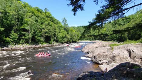 Groups-of-people-white-water-rafting-in-three-large-rafts-on-beautiful-sunny-day