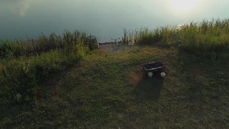 Fishing-rods-on-lakeshore-near-Frydman-village,-Poland