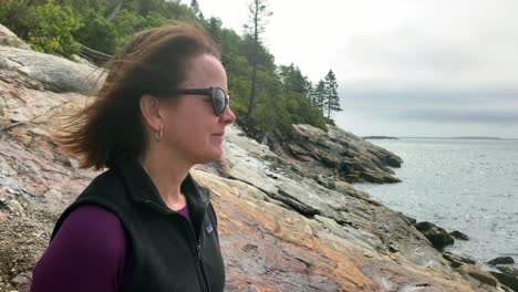 4K-Lady-Contemplates-looking-over-Sand-Beach-in-Acadia-National-Park-near-Bar-Harbor-Maine
