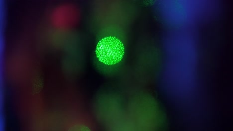 Colorful-out-of-focus-blurred-bokeh-lights-moving-in-the-dark-room,-beautiful-abstract-background,-copyspace