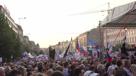 Side-view-of-people-with-flags,-transparents,-banners-and-signs-during-demonstration-against-czech-president-and-premier
