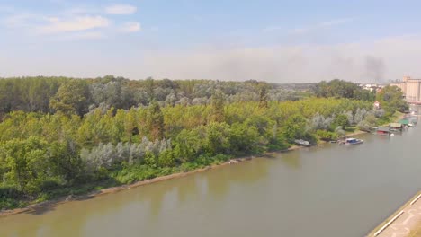 Slow-motion-aerial-footage-of-forest-by-the-river
