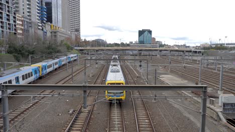 melbourne-PTv-train-passing-under-bridge,-near-Federation-Square,-Melbourne-CBD-,July-2019
