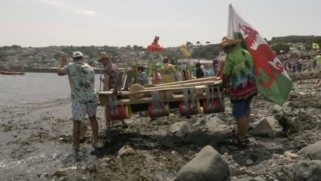 Local-business-teams-ready-to-start-at-the-Newlyn-raft-race-charity-fun-outdoors-event,-Cornwall