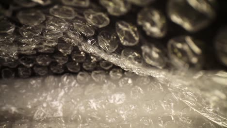 slowly-pulling-out-of-a-bubble-wrap-bag,-top-of-the-bag-flutters-slightly,-focused-on-the-top-half-of-the-bag
