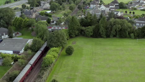 Aerial-view-of-the-Aberdonian-No-60163-Tornado-vintage-steam-train-traveling-through-Aberdeenshire,-Scotland