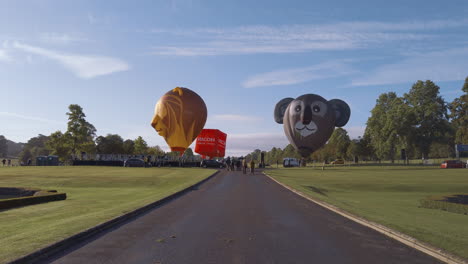 Three-themed-hot-air-balloons-are-deflated-at-the-front-of-Longleat-House-during-the-'Sky-Safari'-Hot-Air-Balloon-event-at-Longleat-Safari-Park