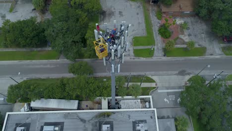 4K-Aerial-video-of-tower-workers-on-cellular-tower