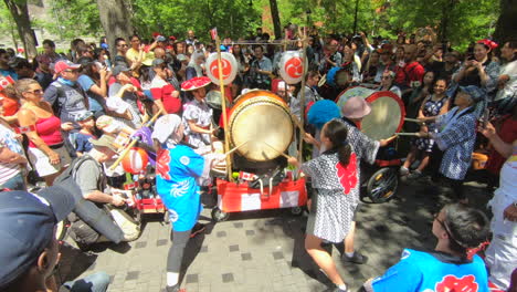 Montreal,-Canada's-day,-drummers-across-Canada-attempt-largest-drum-roll-record,-Guinness-world-record-attempt,-people-watching-percussion-and-drums-outside-show-in-park,-summer-celebration,-music