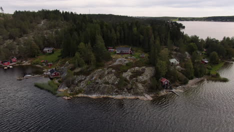 Traditional-red-cottages-on-a-small-Swedish-island,-aerial-shot