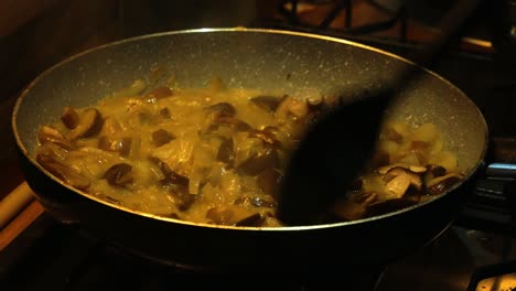 Mixing-mushrooms-and-sour-cream-sauce-on-hot-pan-with-steam-comming-out