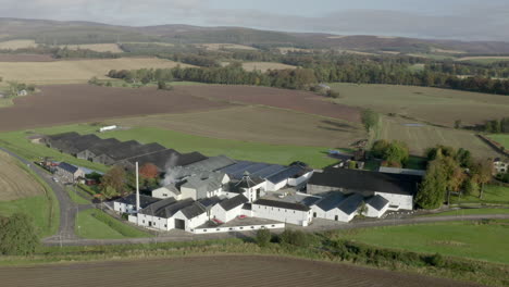 Aerial-view-of-the-Fettercairn-whisky-distillery-on-a-sunny-Autumn-day,-Aberdeenshire