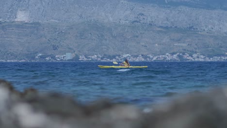 People-on-top-of-paddle-boards-paddling-in-sea-waters-of-Croatia