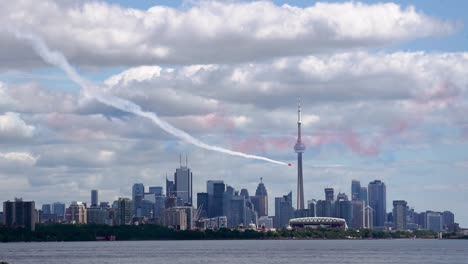 Avión-De-Acrobacias-Rojo-Volando-En-La-Torre-Cn-Y-El-Horizonte-De-La-Ciudad-De-Toronto,-Plano-General