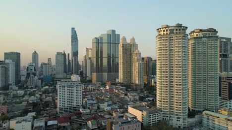 Bangkok-skyline-with-clear-blue-sky,-aerial-dolly-left