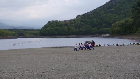 Slowmotion-of-Young-Japanese-Students-Exercising-On-the-Beach-of-Fuji-Lake-in-Japan---Slow-Motion-Shot