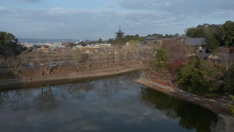 Nara-city-park-and-temples,-Aerial-tilt-shot-in-early-morning-on-beautiful-day