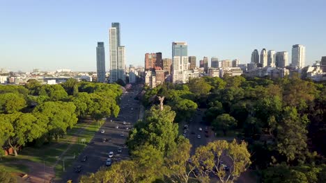 Aerial-revealing-Buenos-Aires-skyline-and-Bosques-de-Palermo-from-behind-a-tree