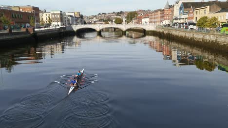 Sunny-day-in-Cork-city,-Ireland-with-rowing-team-practicing-on-river-Lee