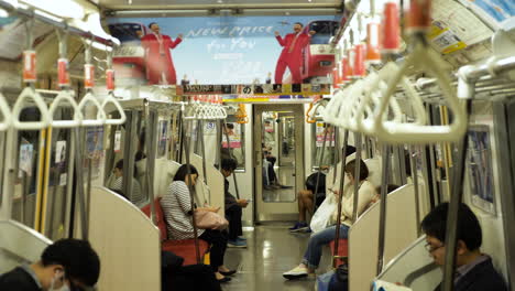 Handrails-hanging-and-japanese-people-commuting-by-subway-in-Tokyo-City