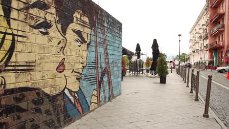 Urban-graffiti-on-wall-by-street-in-Batumi,-Georgia