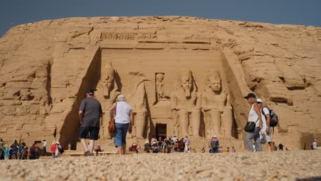 Low-angle-view-of-the-massive-statues-of-Ramses-at-Abu-Simbel,-site-of-two-temples-built-by-the-Egyptian-king-Ramses-II-located-in-Aswan,-southern-Egypt