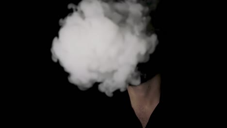 Man-disappearing-behind-cigarette-smoke,-black-background