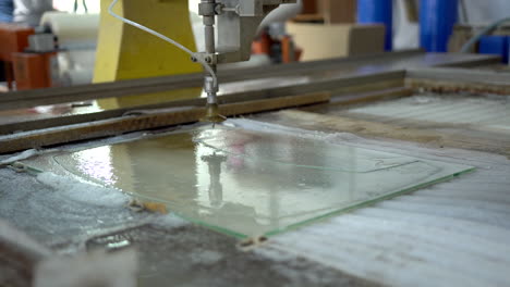 Cleaning-the-finished-final-product-made-from-a-glass-panel-with-CNC-water-jet-cutter
