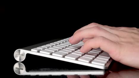Typing-with-two-hands-on-isolated-keyboard.-Close-up