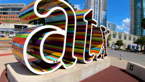 A-low-angle-slow-motion-orbiting-shot-of-the-colorful-ATX-sign-in-downtown-Austin-Texas
