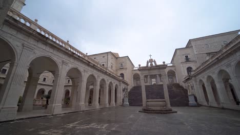 View-of-courtyard-at-abbey-of-Montecassino-with-arches-monumental-structure,-Italy,-handheld-pan