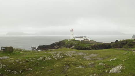 Aerial-establishing-shot-of-solitary-lighthouse-at-Fanad-Head,-northern-Ireland