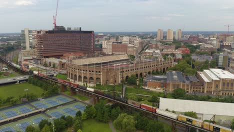 Aerial,-University-of-Pennsylvania-stadium,-Franklin-Field-with-urban-backdrop