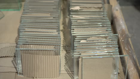 Multiple-glass-panels-stacked-in-a-row-with-a-spacer-made-by-cardboard-in-between