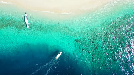 Ausflugsboote,-Die-Durch-Das-Tiefblaue-Meer-Fahren-Und-In-Richtung-Einer-Flachen-Türkisfarbenen-Lagune-In-Der-Nähe-Eines-Exotischen-Sandstrandes-Auf-Bali-Segeln