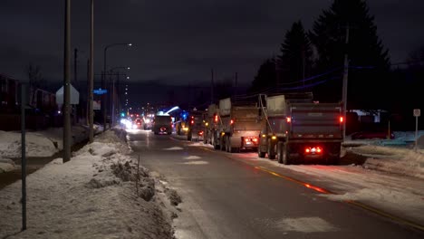 Plows-removing-snow-from-city-streets-at-night