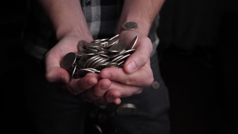 Men's-hands-catch-a-pile-of-coins-falling-from-above