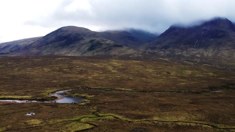 Panning-drone-shot-of-Scottish-river-valley-mountain-landscape