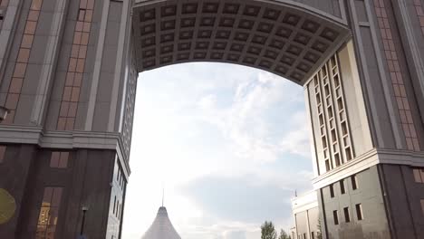 Khan-Shatyr-mall-reveal-through-KazMunayGas-building-arch,-Nur-Sultan,-Kazakhstan