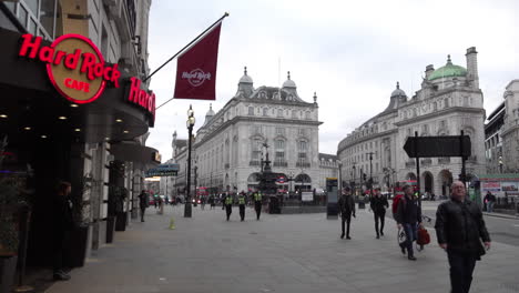 Three-police-officers-walk-through-an-empty-Piccadilly-Circus-the-day-after-UK-Prime-Minister-Boris-Johnson-warns-the-people-to-avoid-all-non-essential-social-contact-due-to-the-Coronavirus-outbreak